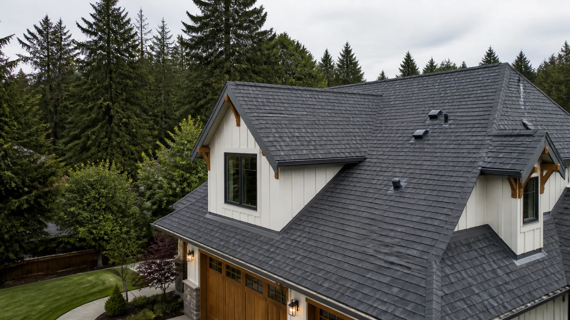 Finished gray residential roof in a Pacific Northwest setting